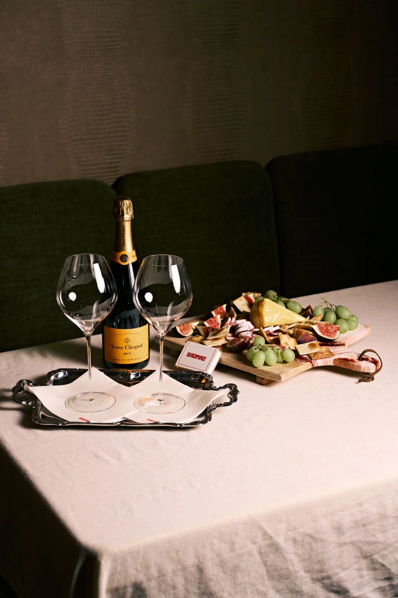 Styled champagne table with glassware and a sharing board