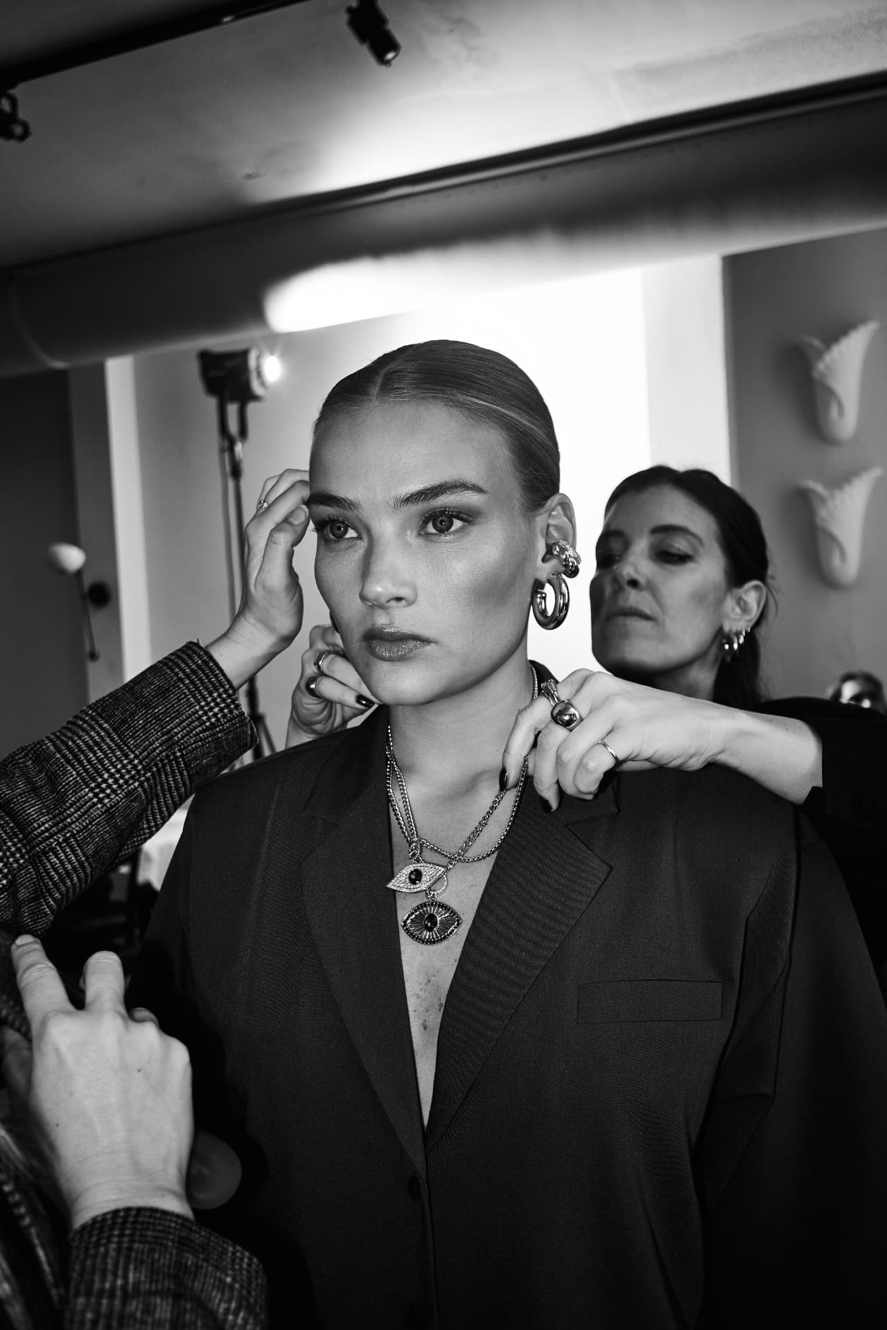 Black and white shot of a model being styled on set