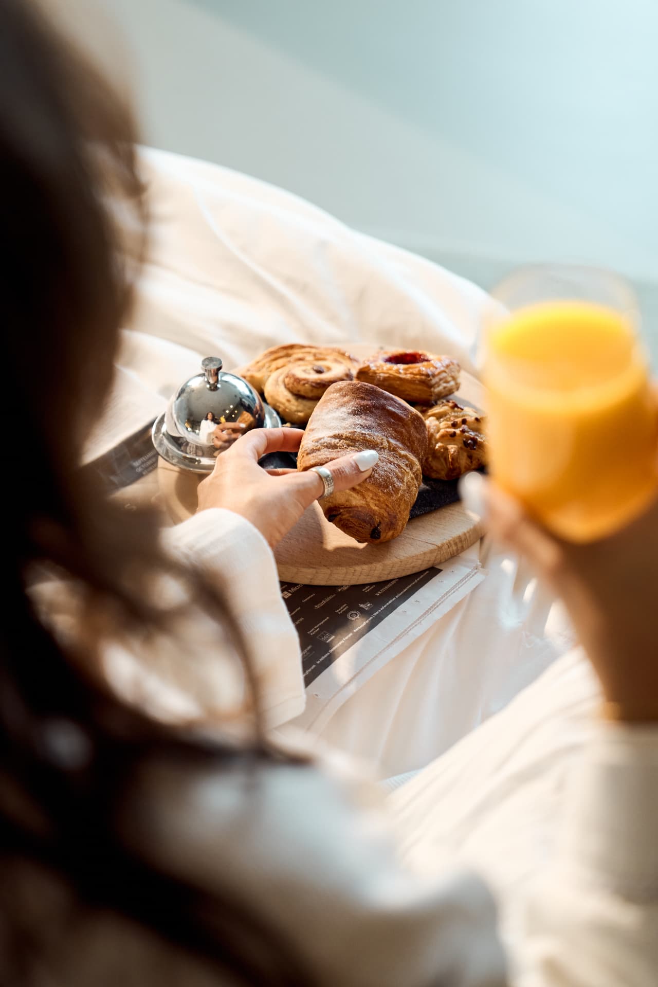 Breakfast tray with pastries and juice in bed