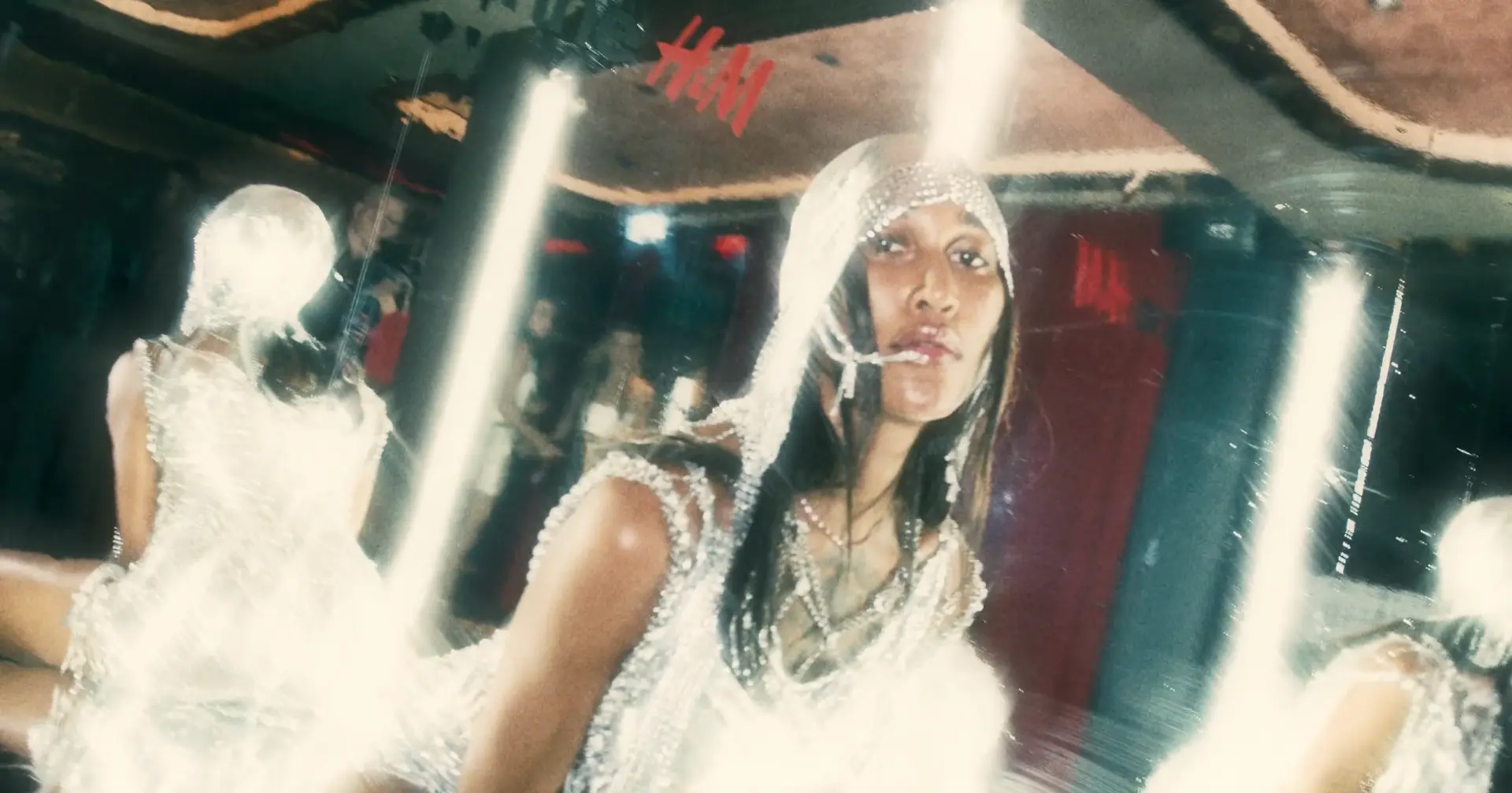 Silver outfits reflected in a mirrored event setting