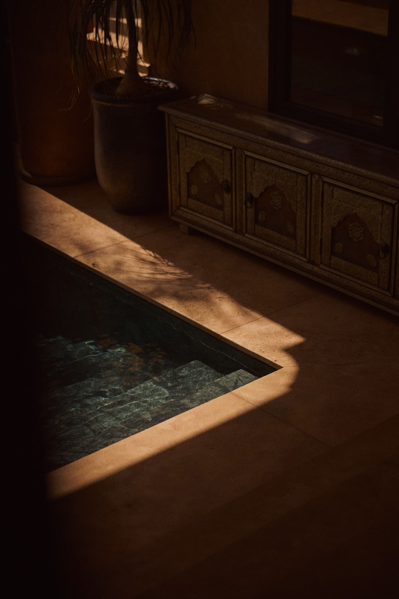 Pool steps cut by sharp afternoon light